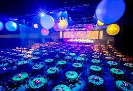 GCCEC event floor set for a gala dinner with blue and purple lighting